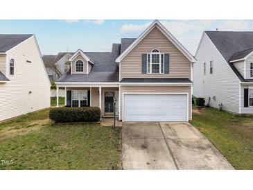 Charming two-story home with a two-car garage and neatly maintained front lawn at 1945 Red Quartz Dr, Raleigh, NC 27610