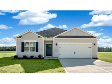 Charming single-story home with gray siding, a two-car garage, and a well-manicured lawn at 195 Hawksmoore Ln, Lillington, NC 27546