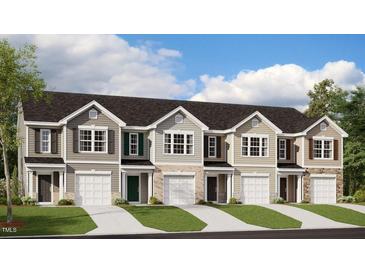 Charming townhome exteriors featuring diverse color schemes and attached garages at 261 Canopy Dr, Graham, NC 27253