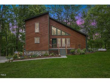 Charming two-story home featuring a brown exterior, stone foundation, and well-manicured front lawn at 6160 Virgilina Rd, Roxboro, NC 27574