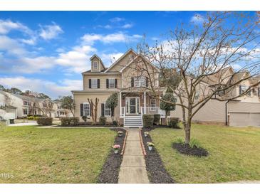 Charming two-story home featuring a landscaped front yard and inviting front porch at 102 Switchback St, Knightdale, NC 27545