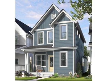 Charming two-story home with blue siding, white trim, covered porch, and well-manicured lawn at 1573 Piney Falls Dr, Wendell, NC 27591