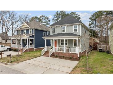 Charming two-story home with a welcoming front porch and well-maintained landscaping at 215 Seventh St, Wake Forest, NC 27587