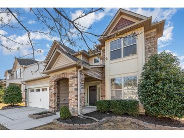Beautiful two-story home boasting a stone facade, well-maintained landscaping, and an inviting front entrance at 3910 Wedonia Dr, Cary, NC 27519