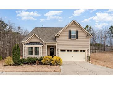 Charming two-story home with light siding, well-kept landscaping, and attached two car garage at 580 Long View Dr, Youngsville, NC 27596