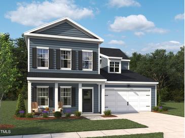 Charming two-story home with a covered front porch, attached garage, and manicured lawn in a desirable neighborhood at 704 Compeer Way # 28, Rolesville, NC 27571