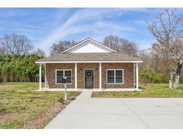 Inviting front exterior of home featuring a charming facade and well-manicured lawn at 735 Alexander Ave, Henderson, NC 27536