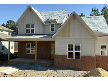 New construction home featuring a brick and siding exterior with modern architectural details at 829 Chapel Ridge Dr, Pittsboro, NC 27312