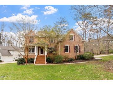 Beautiful brick two-story home with landscaped front yard and inviting entryway at 101 Redfoot Run Rd, Chapel Hill, NC 27516