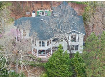 Expansive home with unique architectural design and mature landscaping, complemented by a charming covered porch at 104 Sierra Dr, Chapel Hill, NC 27514