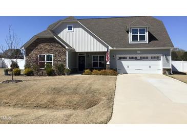 Charming home with a stone and siding facade, a two-car garage, and a well-maintained lawn at 149 Steep Rock Dr, Willow Springs, NC 27592