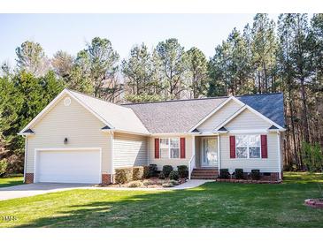 Charming single-story home with red shutters, attached garage, and manicured lawn at 1516 Bradsher Dr, Stem, NC 27581