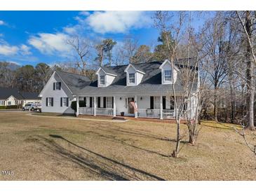 Charming two-story home with a large front yard and a welcoming front porch at 3222 Windmere Dr, Sanford, NC 27330