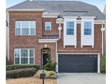 Charming two-story brick home featuring manicured landscaping and a two-car garage at 3929 Glenlake Garden Dr, Raleigh, NC 27612