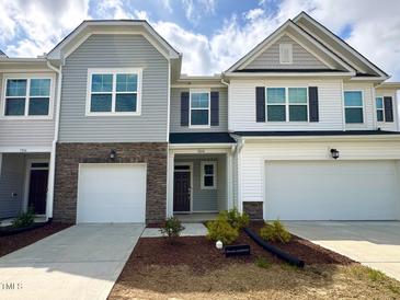 Charming townhome with well-maintained lawn, attached garages, and craftsman-style architecture at 5014 Kota St, Raleigh, NC 27610