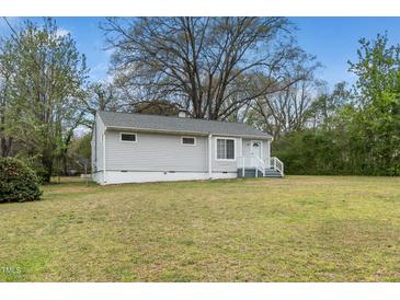 Charming single-story home with light gray siding and a well-maintained front lawn, perfect for first-time buyers at 513 Kenway St, Garner, NC 27529