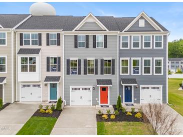 Charming townhomes with colorful doors, one-car garages, and manicured lawns at 609 Silverado Sunset Loop, Wendell, NC 27591