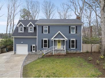 Charming two-story home with blue siding, black shutters, and a bright yellow front door at 8304 Circlewood Ct, Raleigh, NC 27615