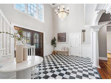 Grand foyer featuring a checkered floor, high ceilings, and a beautiful chandelier at 100 Dunedin Ct, Cary, NC 27511