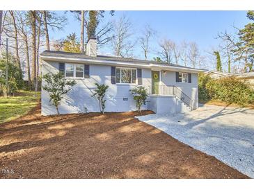 Charming one story brick house with an inviting front yard and well-manicured landscaping at 101 Newell St, Durham, NC 27705