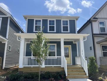 Charming two-story home featuring a welcoming front porch and a bright yellow front door at 1919 Plott Balsam Dr, Wendell, NC 27591