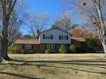 Charming two-story home featuring a brick facade and a well-maintained front yard at 3601 Colonial Ln, Rocky Mount, NC 27804