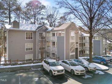 View of the condo exterior, showcasing parking, building details and architectural design at 4631 Timbermill Ct # 301, Raleigh, NC 27612