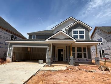 New construction, two-story home with a two-car garage and inviting front porch at 789 Old Station Pointe, Angier, NC 27501