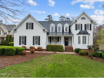 Charming two-story white home featuring a well-manicured lawn, black shutters, and a welcoming front porch at 1188 The Preserve Trl, Chapel Hill, NC 27517