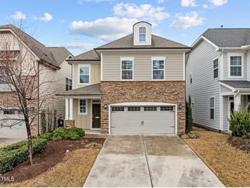 Inviting two-story home featuring stone accents and a two-car garage on a sunny day at 105 Concordia Woods Dr, Morrisville, NC 27560