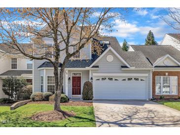 Charming two-story home with a two car garage and a well-manicured lawn at 10707 Edmundson Ave, Raleigh, NC 27614