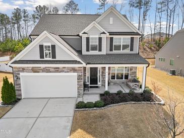 Charming two-story home featuring a covered porch and a stone-accented facade, offering great curb appeal at 115 Cliffview Dr, Garner, NC 27529