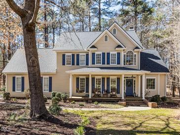 Charming two-story home with blue shutters and a welcoming front porch at 11619 John Allen Road Rd, Raleigh, NC 27614