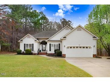 Charming single-story home with a manicured lawn, two-car garage, and lovely curb appeal at 129 Bennett Pl, Clayton, NC 27527