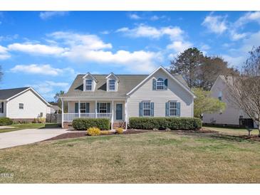Charming single-Gathering home with a welcoming front porch, well-maintained lawn, and beautiful landscaping at 147 Tralee Dr, Smithfield, NC 27577