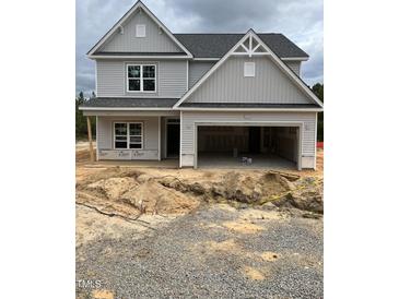 Two-story home featuring a gray exterior, a two-car garage and unfinished landscaping at 200 Dove Rd, Cameron, NC 28326