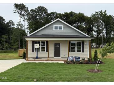 Charming single-story home with a welcoming front porch and well-manicured lawn at 274 Longbow Dr, Middlesex, NC 27557