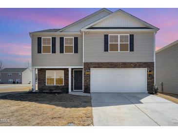 Charming two-story home with stone accents, attached two-car garage, and well-maintained lawn at 2902 Cullens Dr, Graham, NC 27253