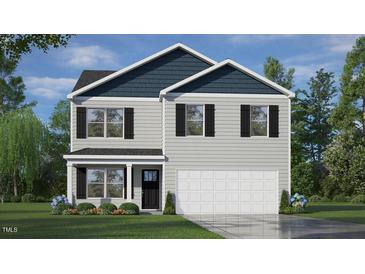 Charming two-story home with gray siding, blue shingled gable, and an attached two-car garage at 43 Red Cedar Way, Fuquay Varina, NC 27526