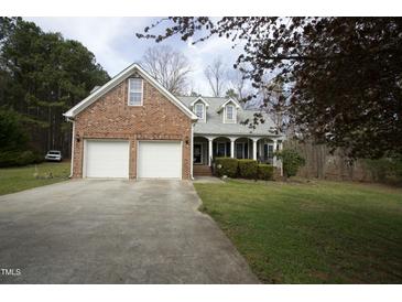 Charming brick and siding home with a two-car garage and covered front porch at 4336 N Greg Allen Way, Oxford, NC 27565