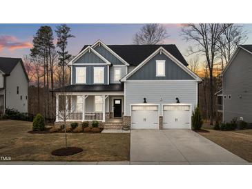Charming two-story home featuring a welcoming front porch and a two-car garage at 505 Marion Hills Way, Knightdale, NC 27545
