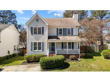 Charming two-story home featuring a cozy front porch and classic blue shutters at 5313 Wenesly Ct, Raleigh, NC 27616