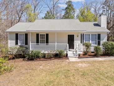 Charming single-story home with a covered front porch and well-maintained landscaping at 5408 Rivercrest Dr, Youngsville, NC 27596