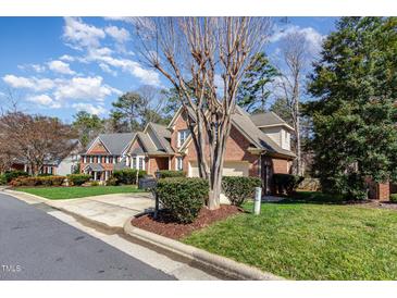 Traditional brick home with well-maintained landscaping and a two-car garage at 5624 Bennettwood Ct, Raleigh, NC 27612