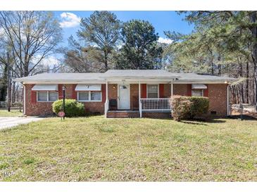 Charming brick home with well-maintained lawn and inviting front porch at 5630 Jones Sausage Rd, Garner, NC 27529