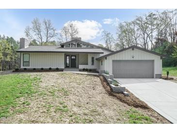 Charming single Gathering home with stylish design details and a well manicured lawn at 610 Flemingtown Rd, Henderson, NC 27537
