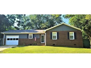Charming single-story home with brick accents, well-maintained lawn, and attached garage at 107 Ware Ct, Garner, NC 27529
