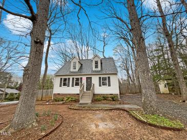 Charming cottage-style home with dormer windows and mature trees in a quiet neighborhood setting at 1100 Walter Clark Dr, Hillsborough, NC 27278