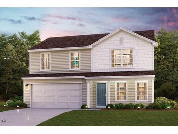 Charming two-story home with a light blue door, manicured lawn, and attached two-car garage at 112 Ferry Ct, Rocky Mount, NC 27804