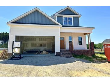 New two-story home featuring a two-car garage and a classic facade with blue and white accents at 163 Noramac Ct, Selma, NC 27576